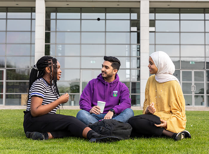 three international students eating lunch outside on UCD campus